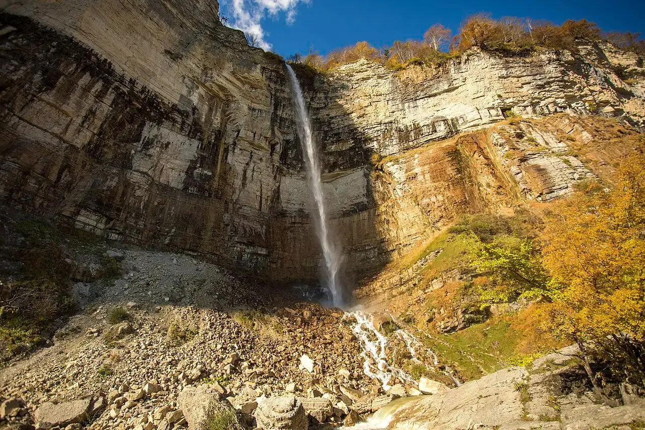 Kinchkha waterfall dropping over a high cliff