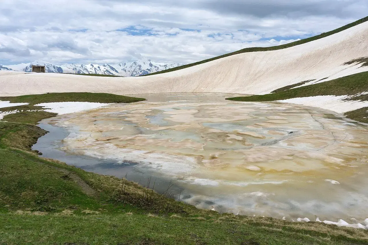 Koruldi lakes partly covered with snow on an alpine plateau